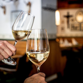 Toast with wine at the Murauer Gasthof Hotel Lercher.